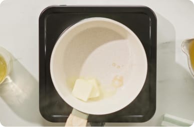 Melt butter in hot sauce pan.